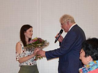 Hans-Theo Krauhausen bedankt sich mit einem Blumenstrauß bei der Künstlerin Hanna Feegers